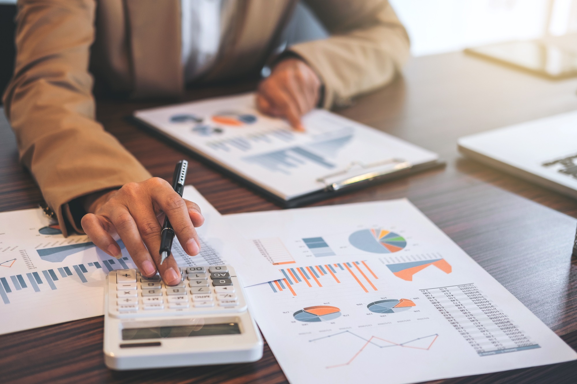 Business Financing Accounting Banking Concept, businesswoman doing finances and calculate about cost to real estate investment and in other, tax system.